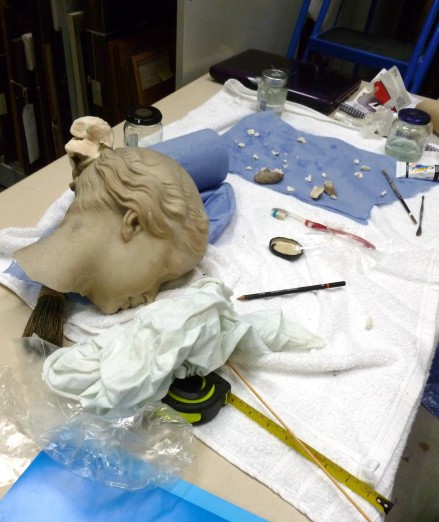 Conservation tools and the head of the sculpture