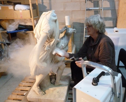 Jane steam cleaning the sculpture with distilled water