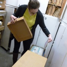 Juliette opening a box in the archive