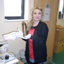 Showing the others a donation object and an Entry form. This is a money box made from a shell casing - Trench Art. It is a money box honest!